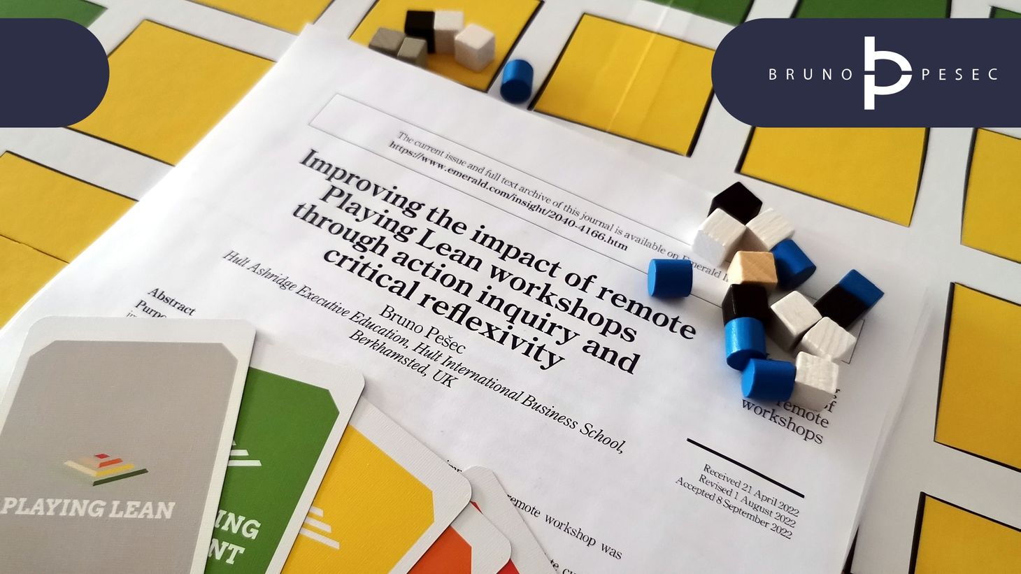 Academic paper printed and placed on top of Playing Lean board game